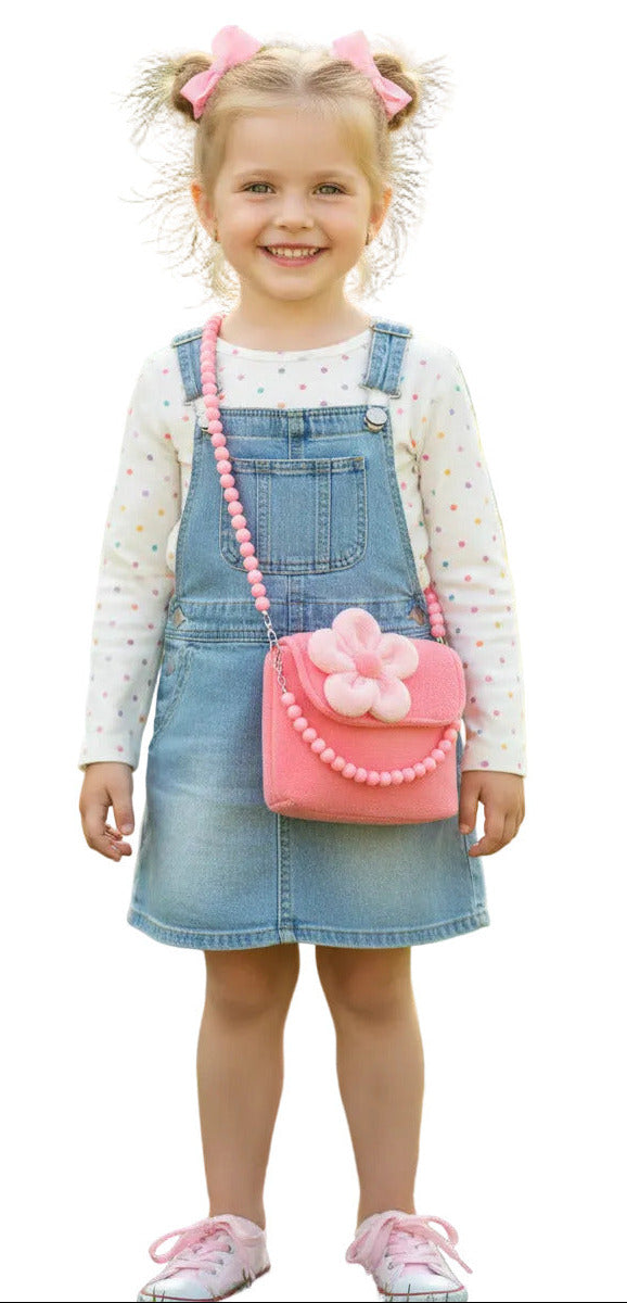 Girl wearing a pink plush bag with a flower on a light background