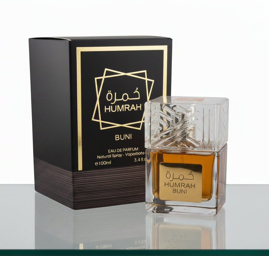 Humrah Buni Eau de Parfum bottle and black gift box with gold geometric star design displayed on reflective surface — 100ml natural spray men's fragrance.