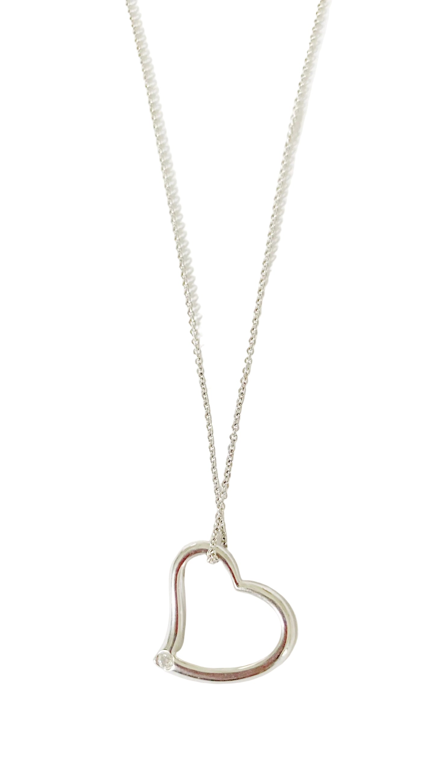 A sterling silver heart pendant necklace with a red heart-shaped detail in the center, displayed on a silver chain against a white background.