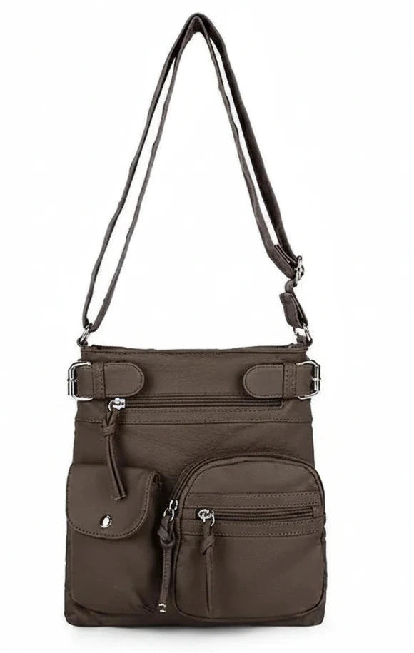 A dark brown nylon crossbody bag with multiple front pockets and a long shoulder strap, shown against a plain white background.