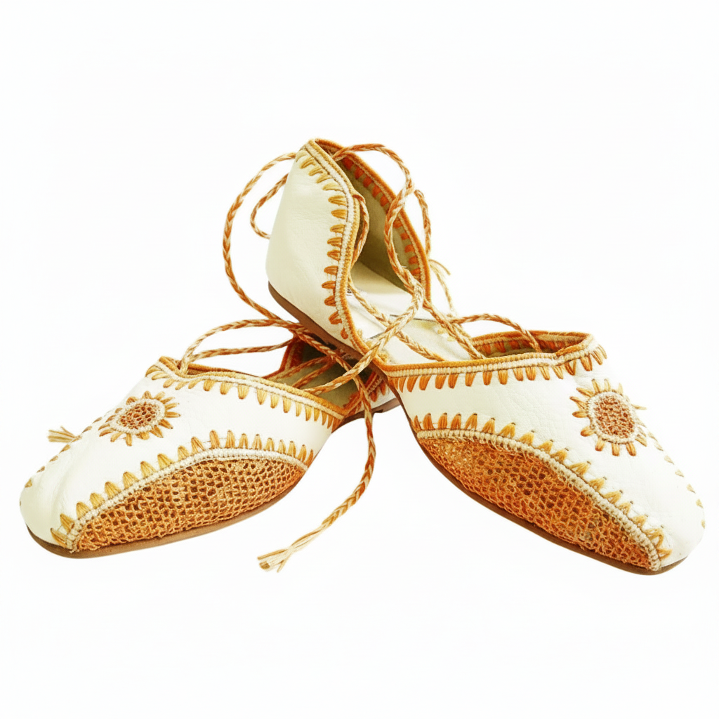 A pair of orange leather slippers with sequins and a brown faux leather carrying strap.