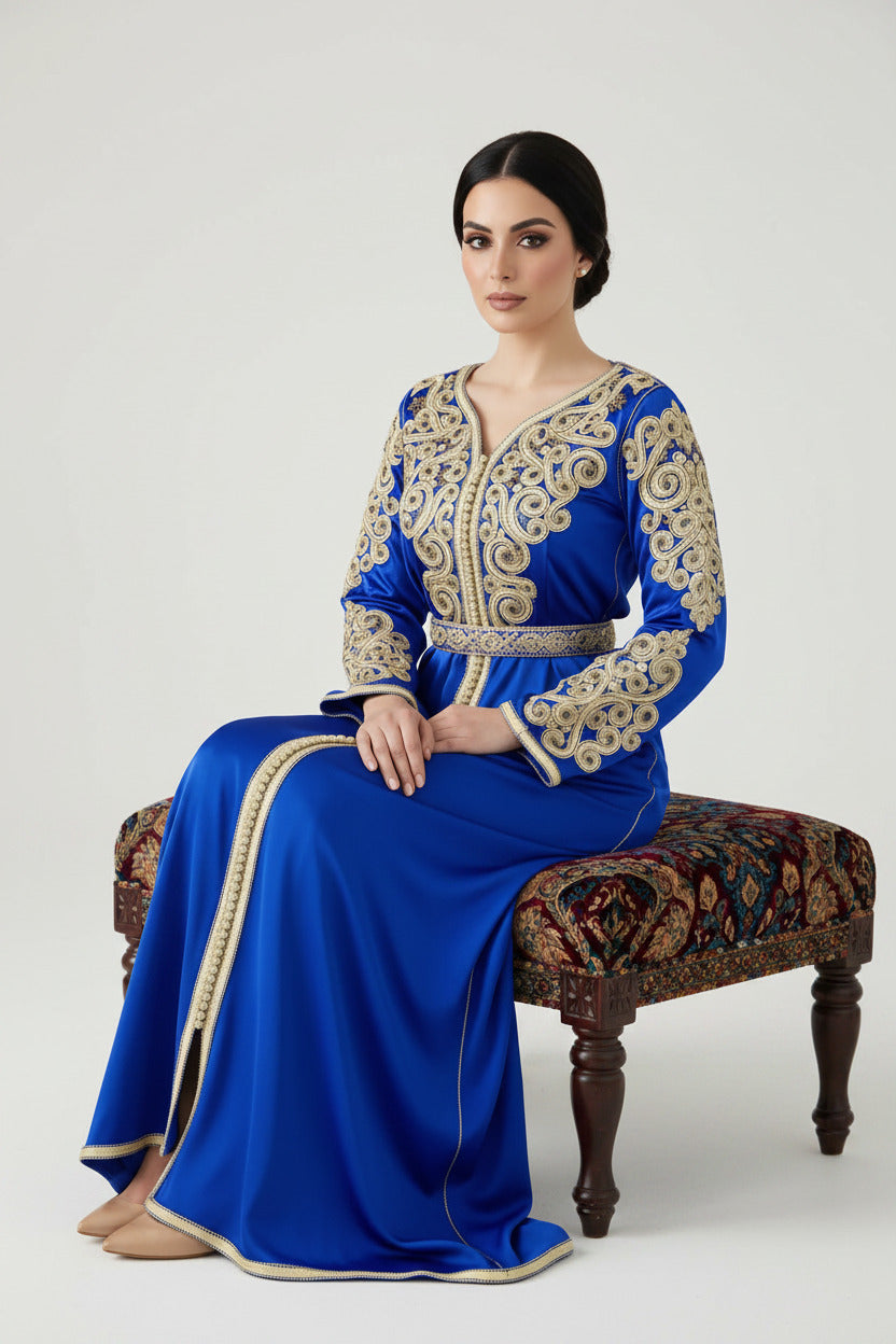 Woman wearing a blue and gold embroidered dress on a white background