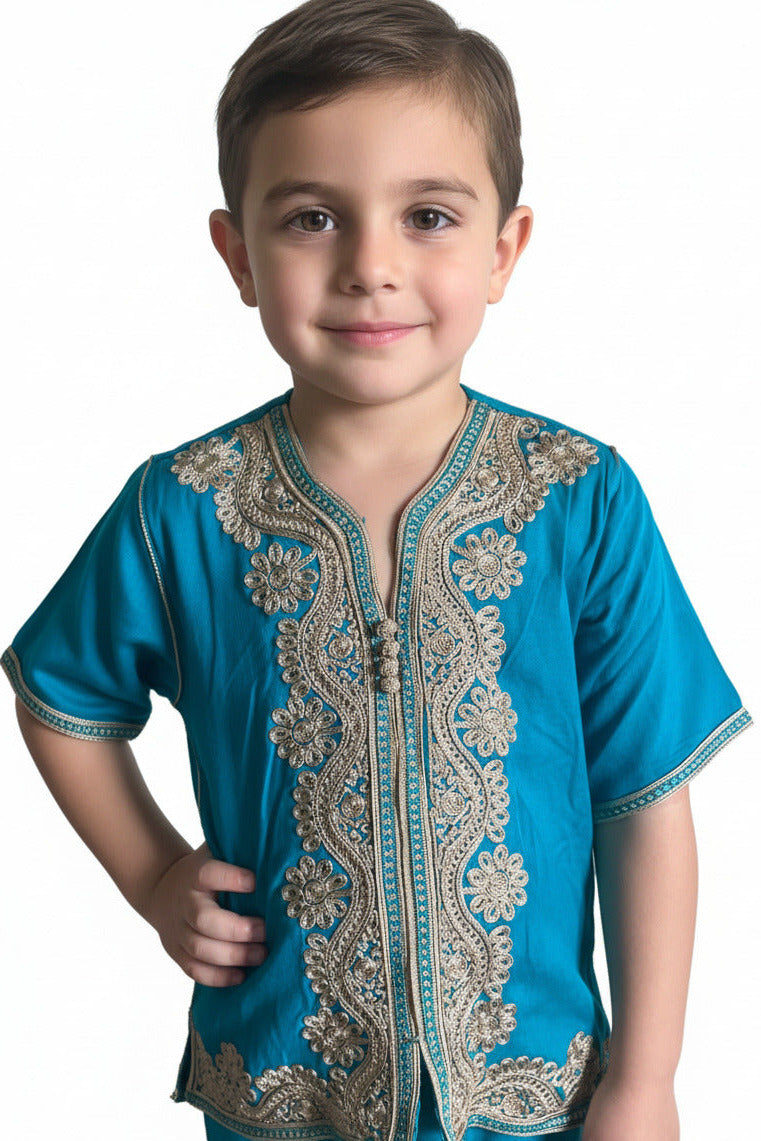Child wearing a blue embroidered shirt on a white background