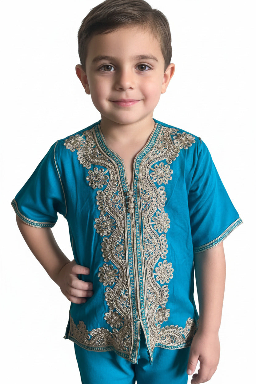 Child wearing a blue embroidered shirt on a white background
