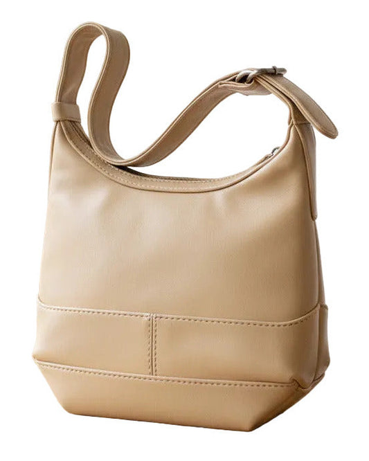 A beige faux-leather shoulder bag with a wide strap and a horizontal seam detail on the front, shown against a plain white background.