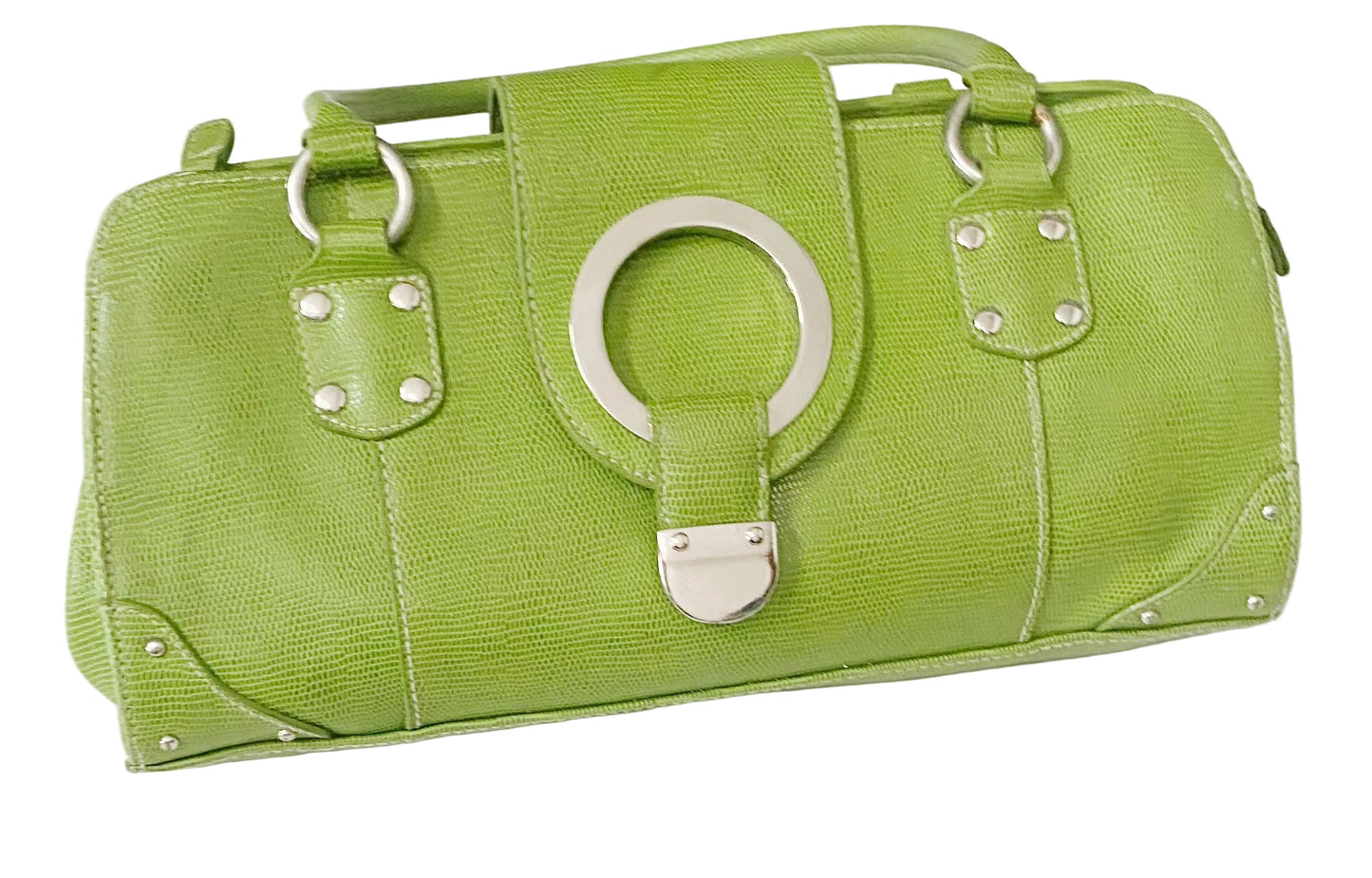 A lime green textured leather handbag with a large silver-tone circular ring detail on the front flap, silver studs, and a top handle, shown against a plain white background.