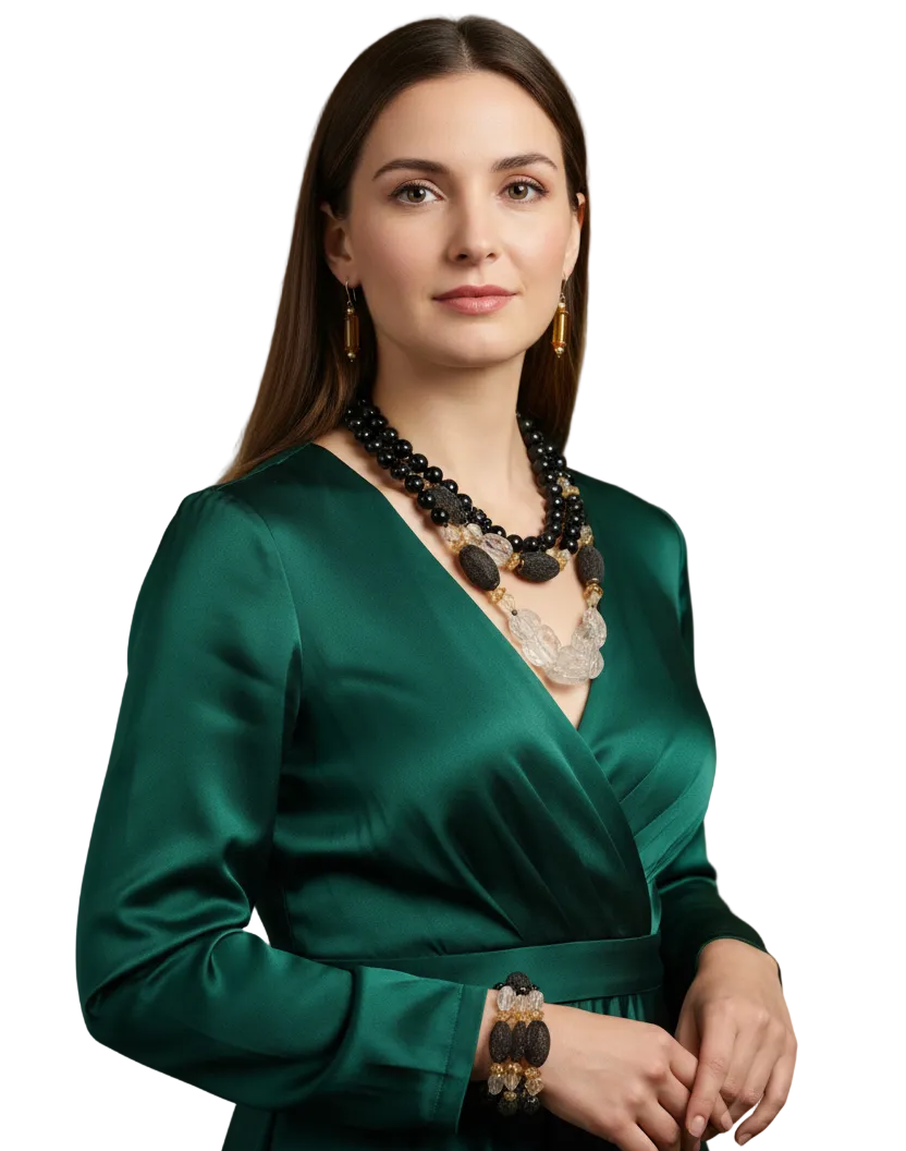 Woman wearing a set of black tourmaline, white sapphire necklace, matching bracelet and complementary gold tone earrings--TTP