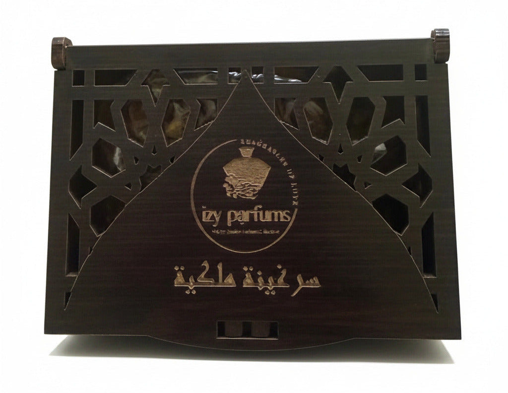 A dark brown wooden incense box with intricate geometric cutouts and gold Arabic calligraphy, displayed on a white surface.