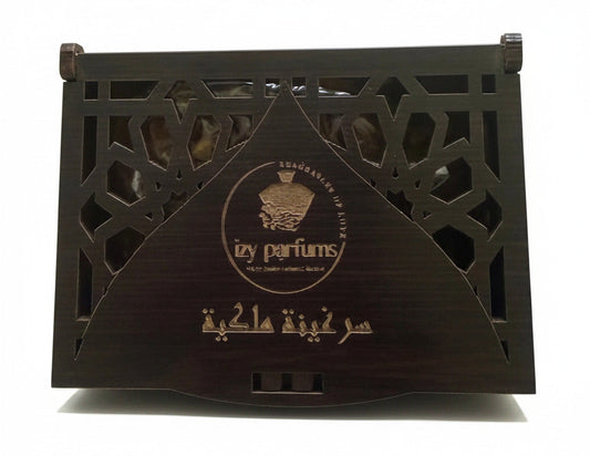 A dark brown wooden incense box with intricate geometric cutouts and gold Arabic calligraphy, displayed on a white surface.