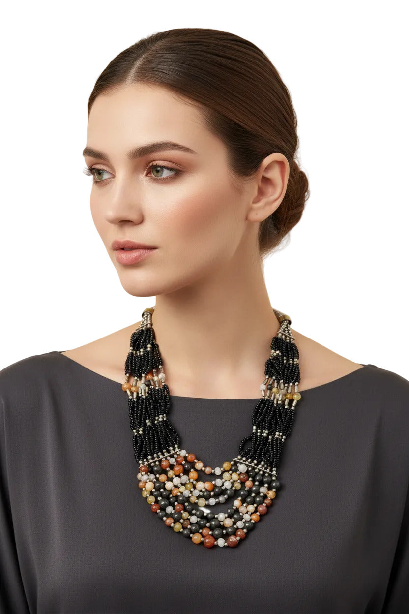 Woman wearing a lava rock stone Berber-style necklace with amber resin beads--TTP 