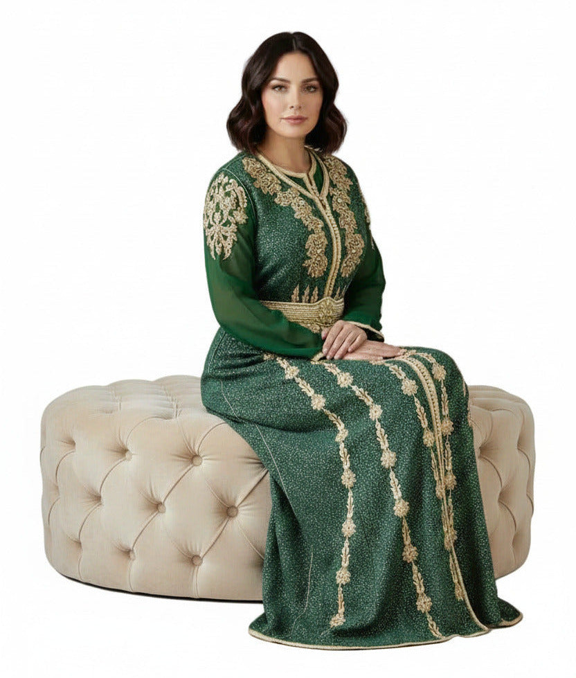 Woman wearing a green and gold embroidered dress on a white background