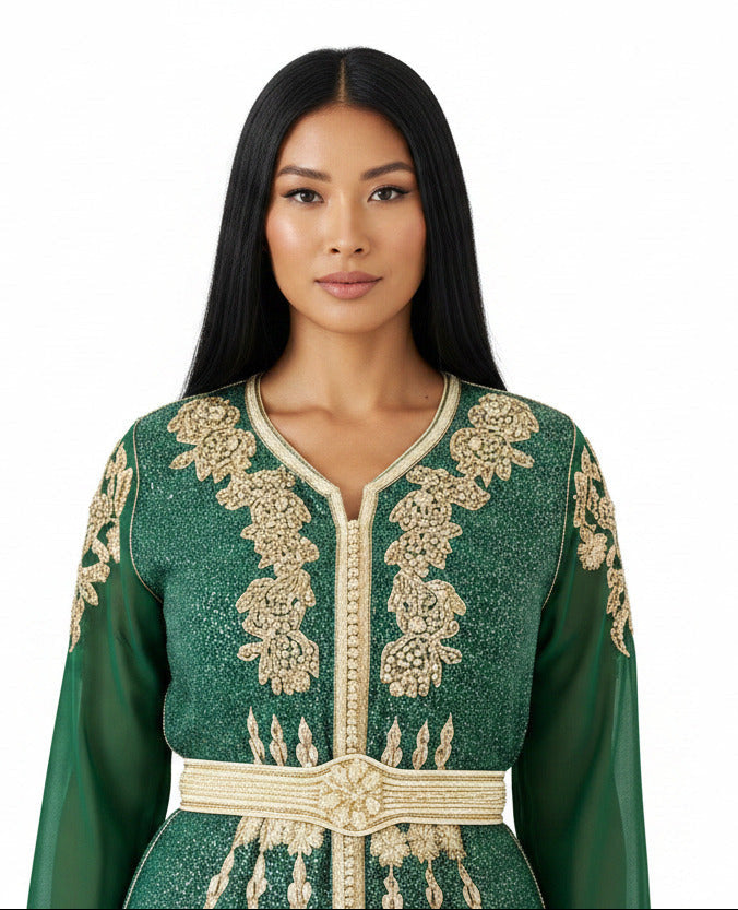 Woman wearing a green and gold embroidered dress on a white background