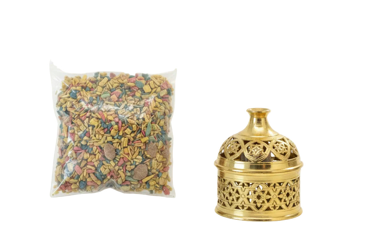 A clear plastic resealable bag filled with multicolored dry Royal Serghina incense dried leaves, and a bakhoor burner  photographed on a plain white background--TTP
