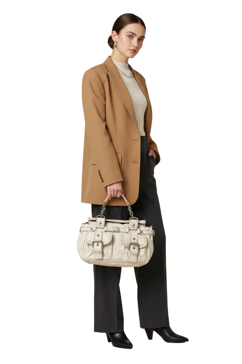 An off-white faux leather handbag with multiple front flap pockets, silver-tone buckle details, and a top handle, shown against a plain white background.