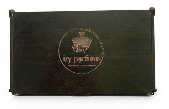 A dark brown wooden presentation box with a laser-engraved circular Izy Parfums logo. The box is photographed from a top-down view on a white surface--TTP
