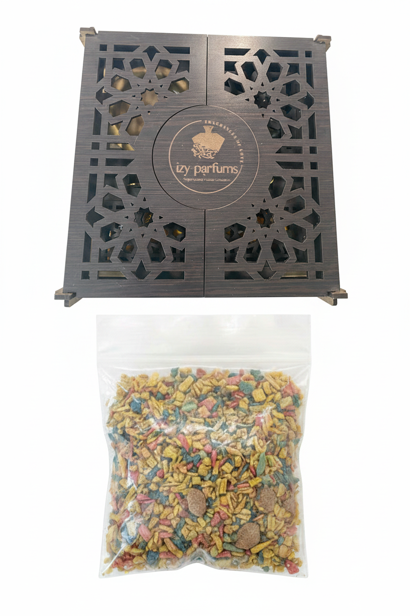 A dark brown wooden diffuser box with intricate geometric cutouts and a circular logo reading 'izy parfums', shown alongside a clear plastic bag filled with colorful dried incense on a white background.