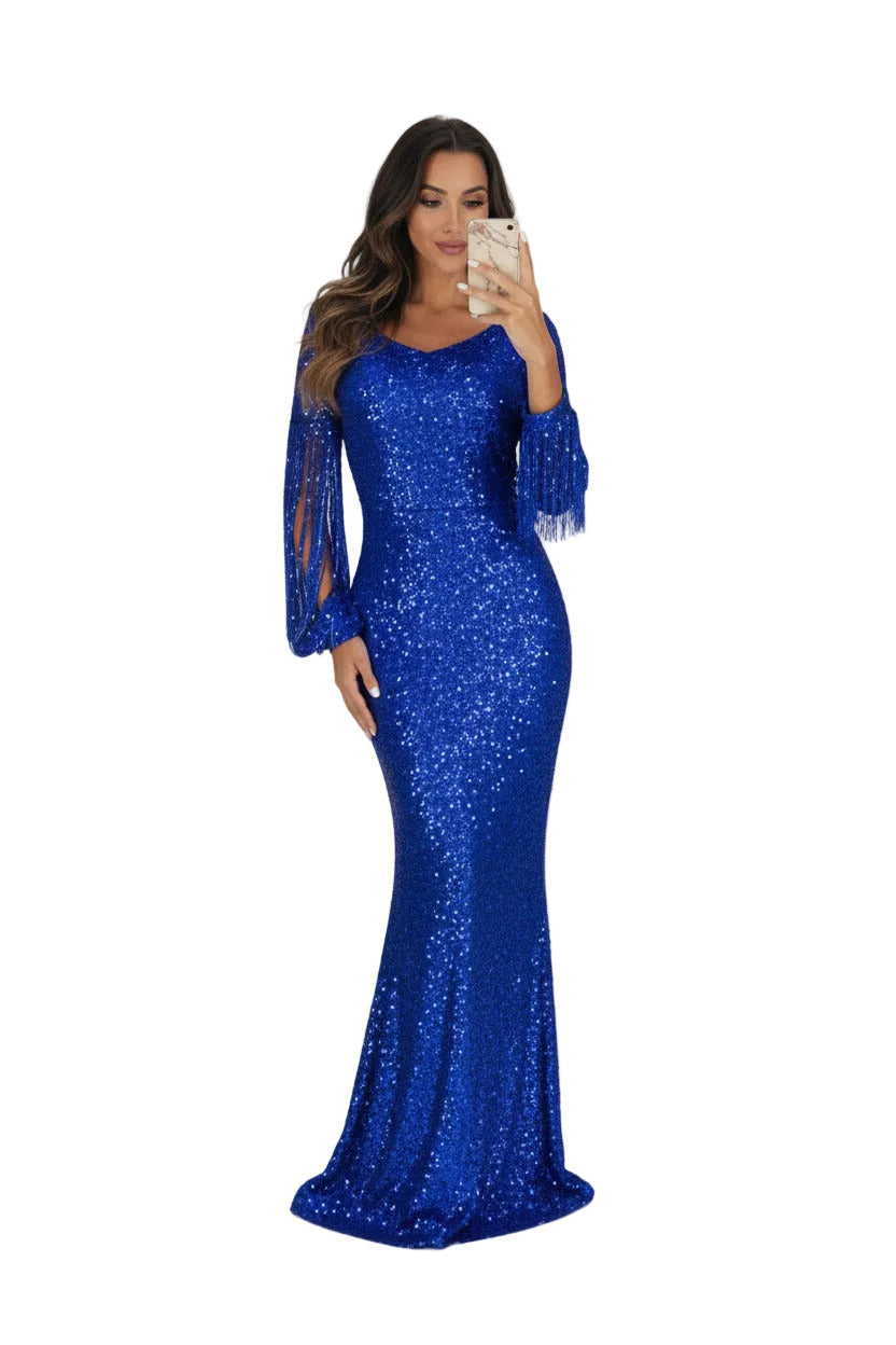 Woman wearing a blue sequin dress with sheer sleeves on a white background