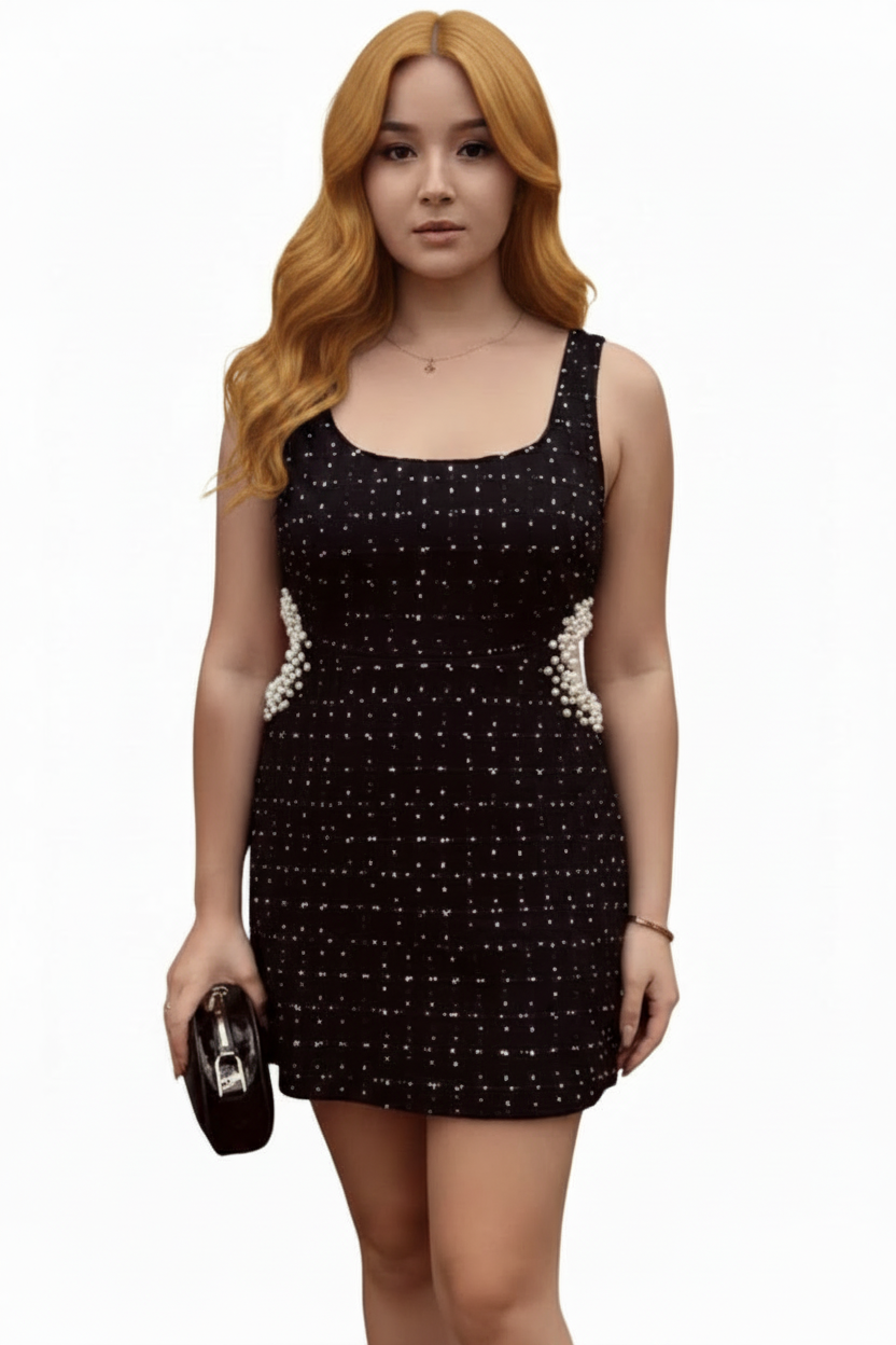 Woman wearing a black dress with white patterns on a white background