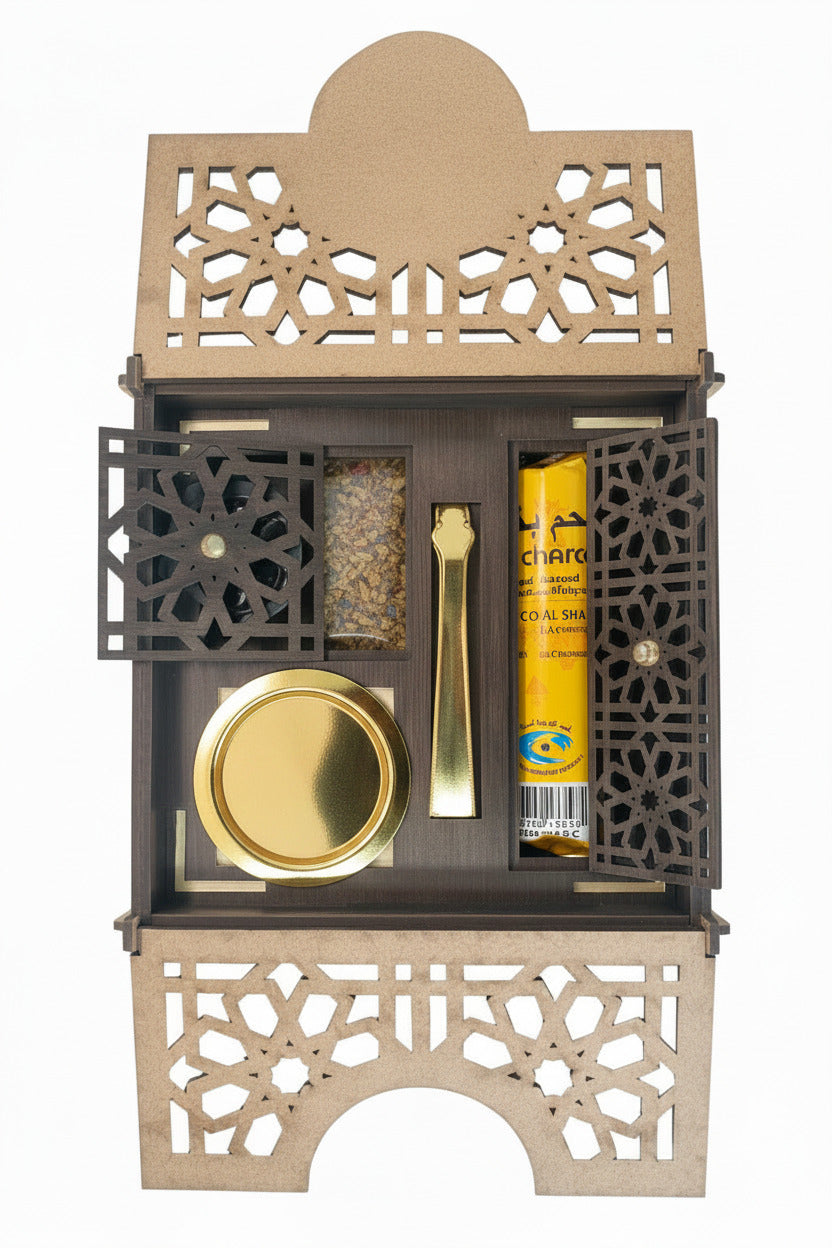 A wooden incense set with geometric laser-cut panels, containing a charcoal stick, gold metal tong, round gold colored incense holder, and a small bag of dried incense herbs, shown on a white background.